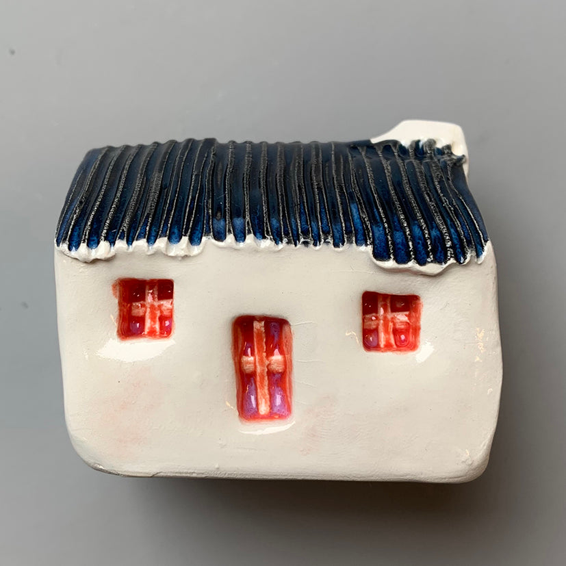 handmade ceramic croft houses with a corrugated metal roof