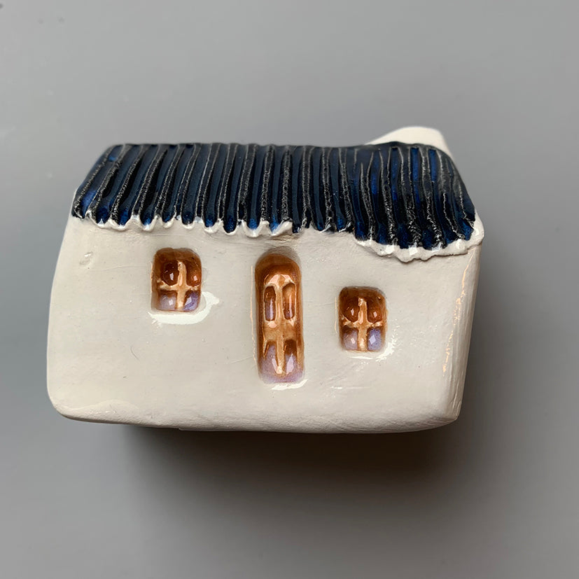 handmade ceramic croft houses with a corrugated metal roof