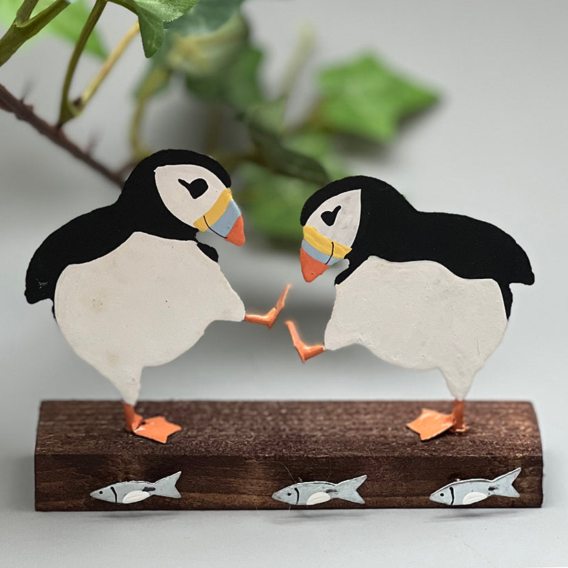 Two puffins on wood