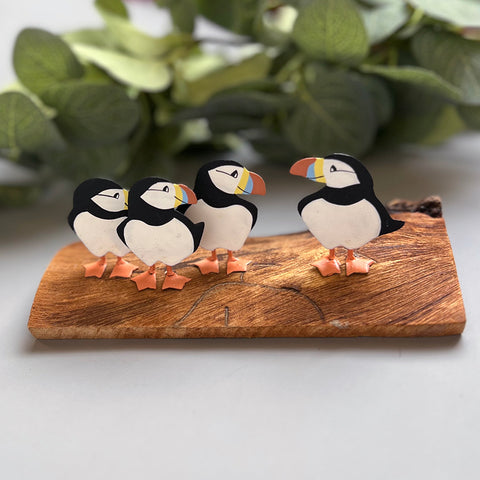 Four puffins on wood