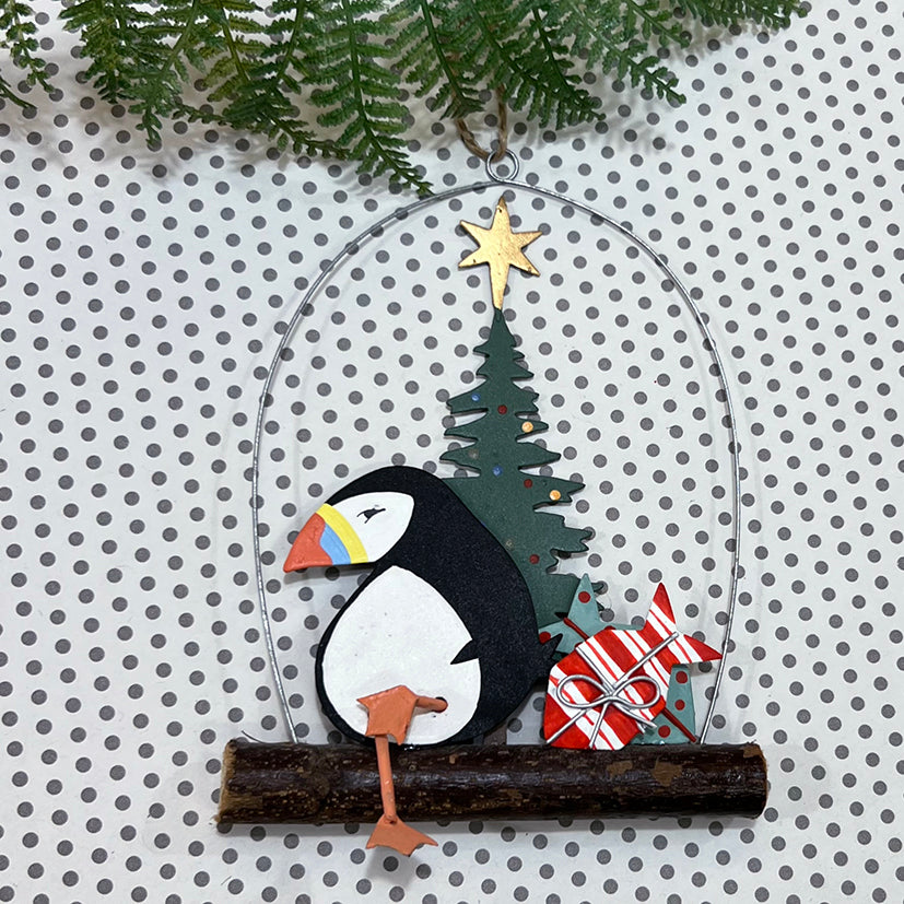 Relaxing christmas puffin on driftwood