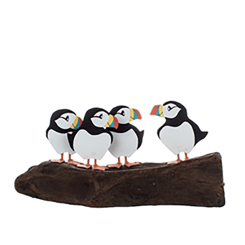 4 chatting puffins on driftwood
