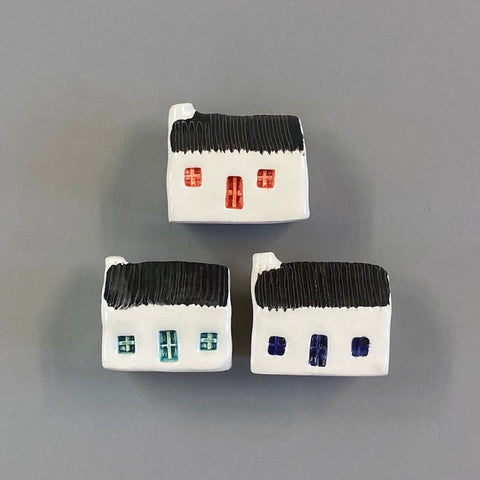 handmade ceramic croft houses with a corrugated metal roof