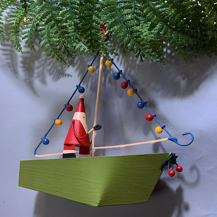 Santa in a boat with fairy lights