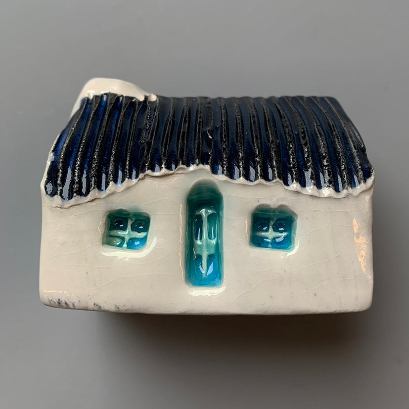 handmade ceramic croft houses with a corrugated metal roof